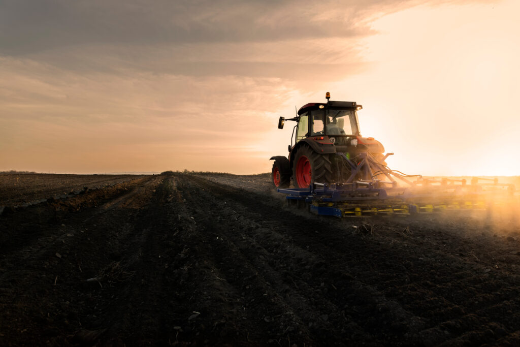 Farmer preparing his field in a tractor ready for spring.